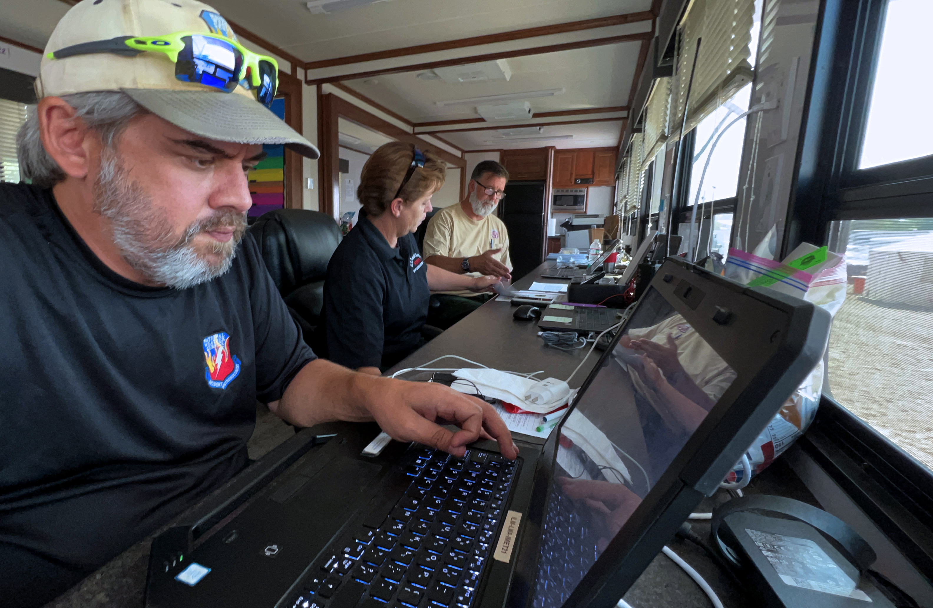 IMET Terry Lebo creates a forecast as he works alongside a fire behavior analyst and fire behavior analyst trainee to provide support to contain the McKinney Fire in California on August 26, 2022. 