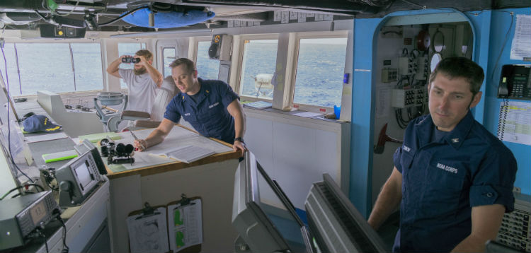 Captain Dan Simon, right, and Ensign Ryan Musick, center, navigate NOAA Ship Ronald H. Brown using the electronic chart display and paper charts, while General Vessel Assistant Jacob Dombrowski, left, scans the horizon for other ships and any hazards. The Ron Brown successfully navigated through many seas across the globe with varying levels of navigational hazards during the 8 month expedition.
