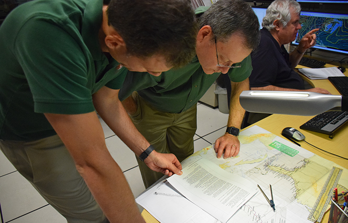 The size and strength of the wind field are critical in determining where warnings are placed. Storm Surge Team Leader Jamie Rhome and chief of forecast operations James Franklin peer over the latest plot of Hermine.