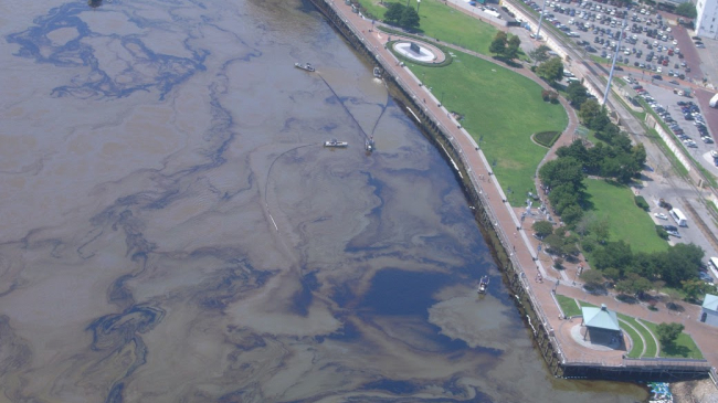 On  July 23, 2008,  the chemical tanker Tintomara collided with fuel barge DM932 on the Mississippi River, near New Orleans, Louisiana. Shown here is an aerial view of the resulting oil spill.