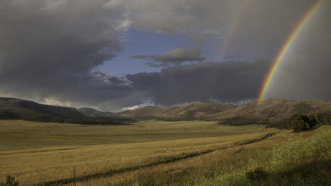 Photo showing a rainbow over the Valles Grande in New Mexico on August 14, 2015. Photo courtesy of Stephen Lee - Submitted to Weather in Focus Photo Contest.