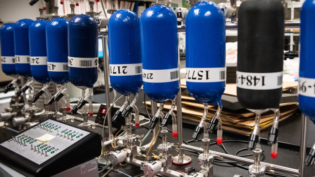 Flasks containing air samples from around the world are lined up on a manifold for intake processing and analysis at NOAA's Global Monitoring Laboratory.