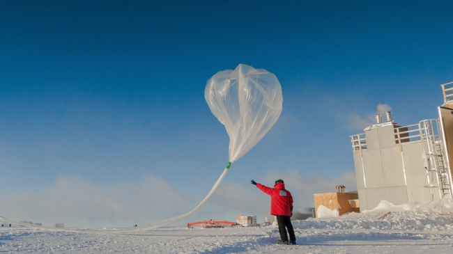 Researchers release a weather balloon carrying an ozone sonde (airborne instrument) during the 2016 ozone hole research season at the South Pole.