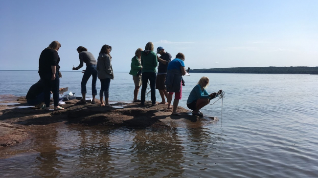 Teachers collect water quality data from the shoreline of Lake Superior during the Rivers2Lake Summer Institute.