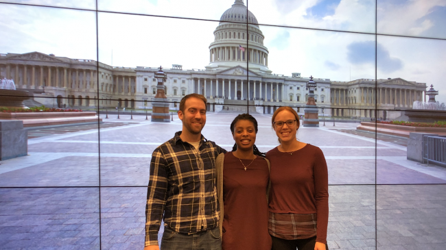 Rich Buzard, Shanna Williamson, and Alexis Cunningham stand for a group photo in front of the United States Capitol.