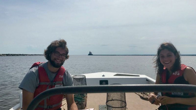 NOAA Scholar Kasey Hirshfeld (right) sampling for invasive rusty crayfish in Superior Bay, alongside a student research intern from a local university.
Kacey Hirshfeld, a rising senior at the College of Charleston, spent her summer internship at the Lake Superior NERR in Superior, Wisconsin. She worked in the Reserve’s Coastal Training Program to create a shipboard learning experience for coastal decision makers in the Western Lake Superior area, which demonstrated the connection between land-use