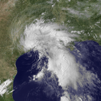 Tropical Storm Allison on June 5, 2001, early in its life, strikes the Gulf coast of Texas and Louisiana. Satellite image is from GOES-8, channel 1 visible mixed with the cloud-free blue marble as background.