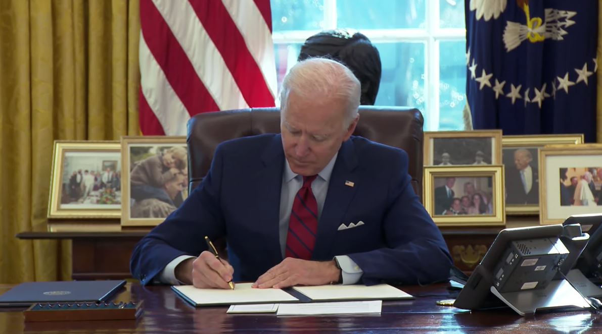 President Biden signing Executive Order 13985 on January 20, 2021