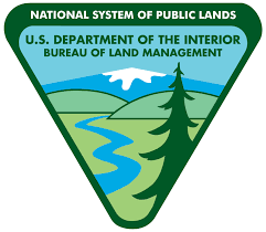 Logo with the text "National System of Public Lands, U.S. Department of the Interior, Bureau of Land Management" above an illustration of a snow capped mountain, hills, a stream and a tree.