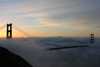Golden Gate bridge towers sticking up above the marine layer.