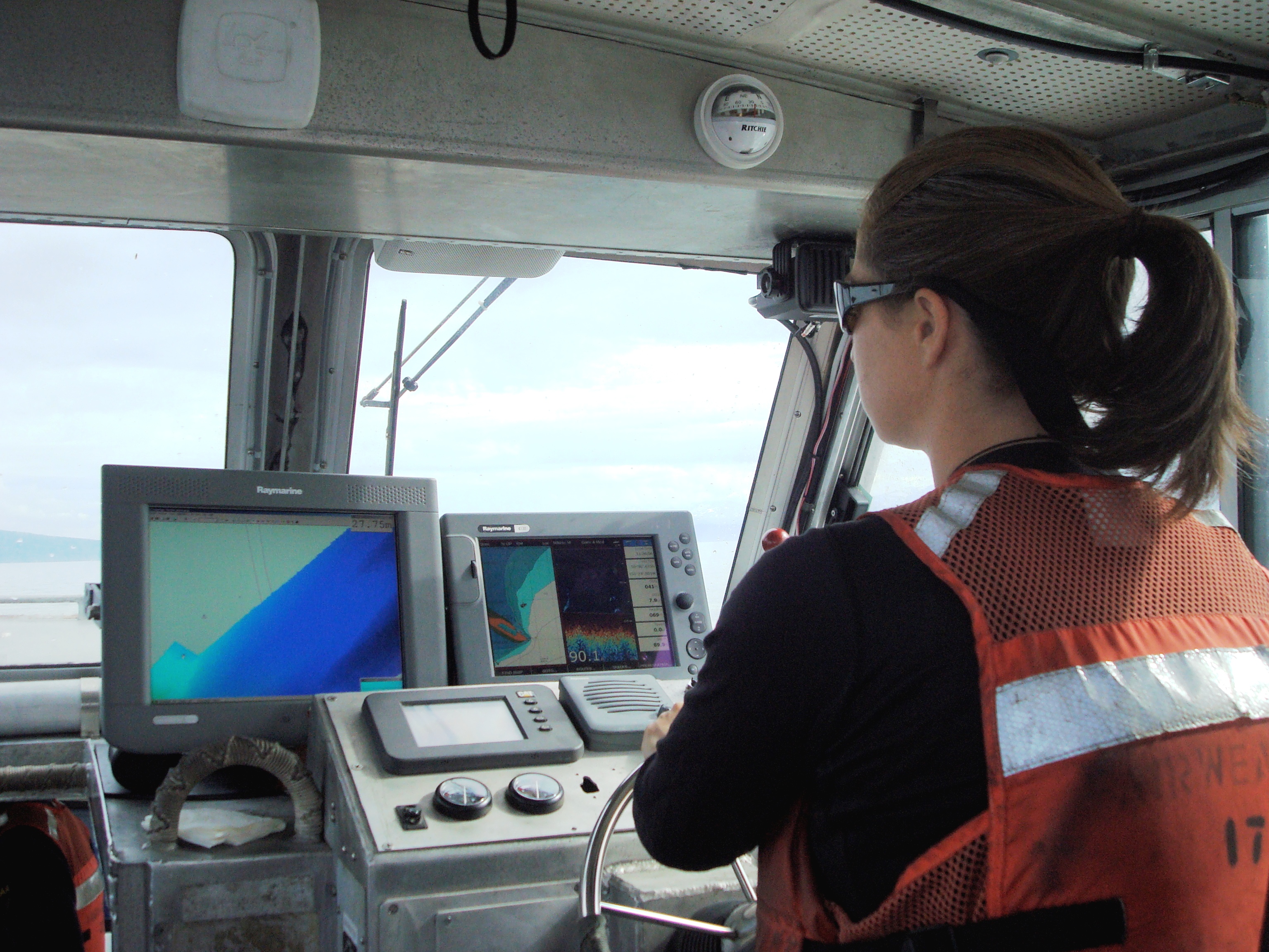 A survey launch coxswain operating one of NOAA Ship Fairweather's launches in 2008.
