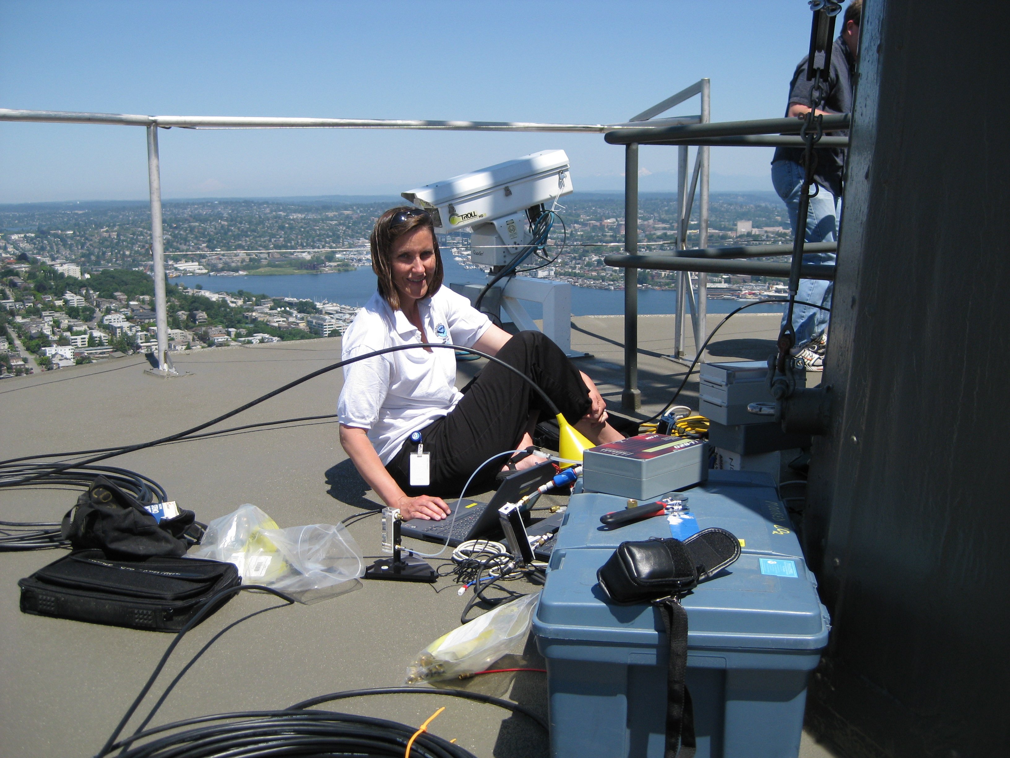 NOAA scientist Stacy Maenner working on the CO2 sensor installed on top of Seattle’s Space Needle.