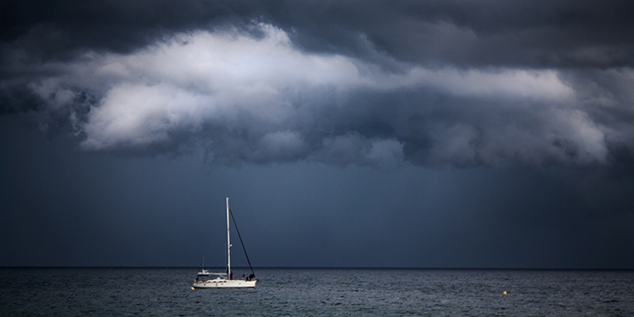 A sailboat in stormy conditions. Check the marine weather forecast before you depart, and carry a weather radio while on the water. 