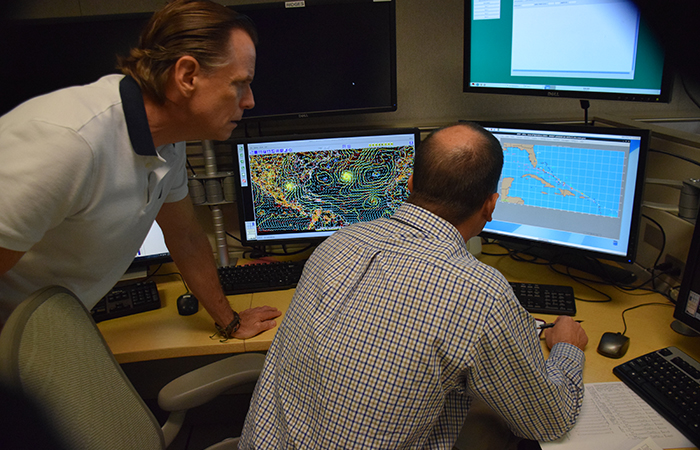 Data is critical to an accurate forecast. Hurricane forecaster & Navy Liaison Dave Roberts study the latest computer models on August 24 with senior hurricane specialist Daniel Brown regarding the disturbance that would become Hermine as it approaches the Caribbean Islands.