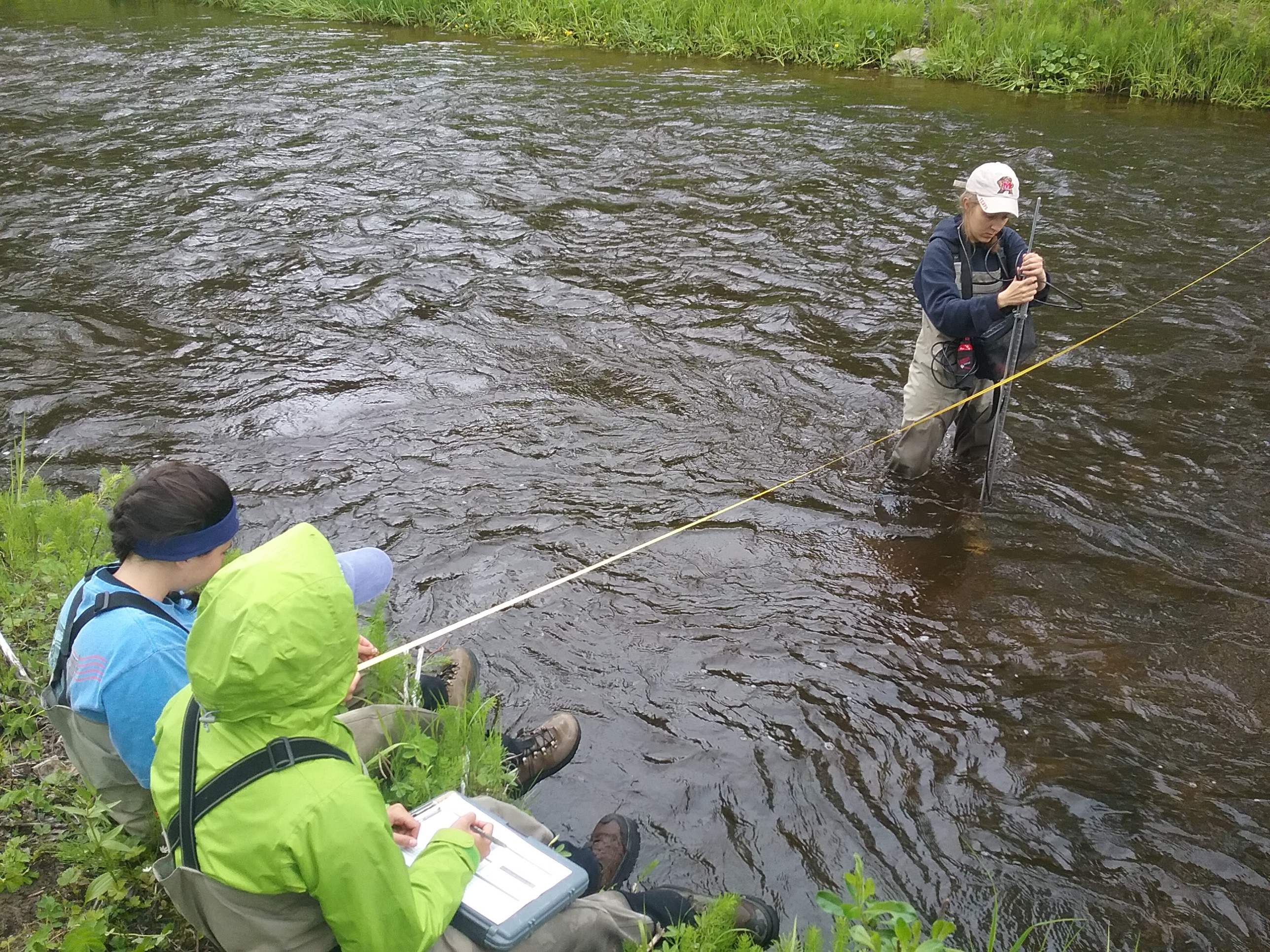 Anna Lowien, NOAA Hollings Scholar Class of 2017, collecting water velocity measurements of the salmon-bearing Stariski Creek in the Kenai Lowlands of Alaska. Also pictured: Megan Hazlett (left) and Ashley Bang (right), NOAA Hollings Scholars.