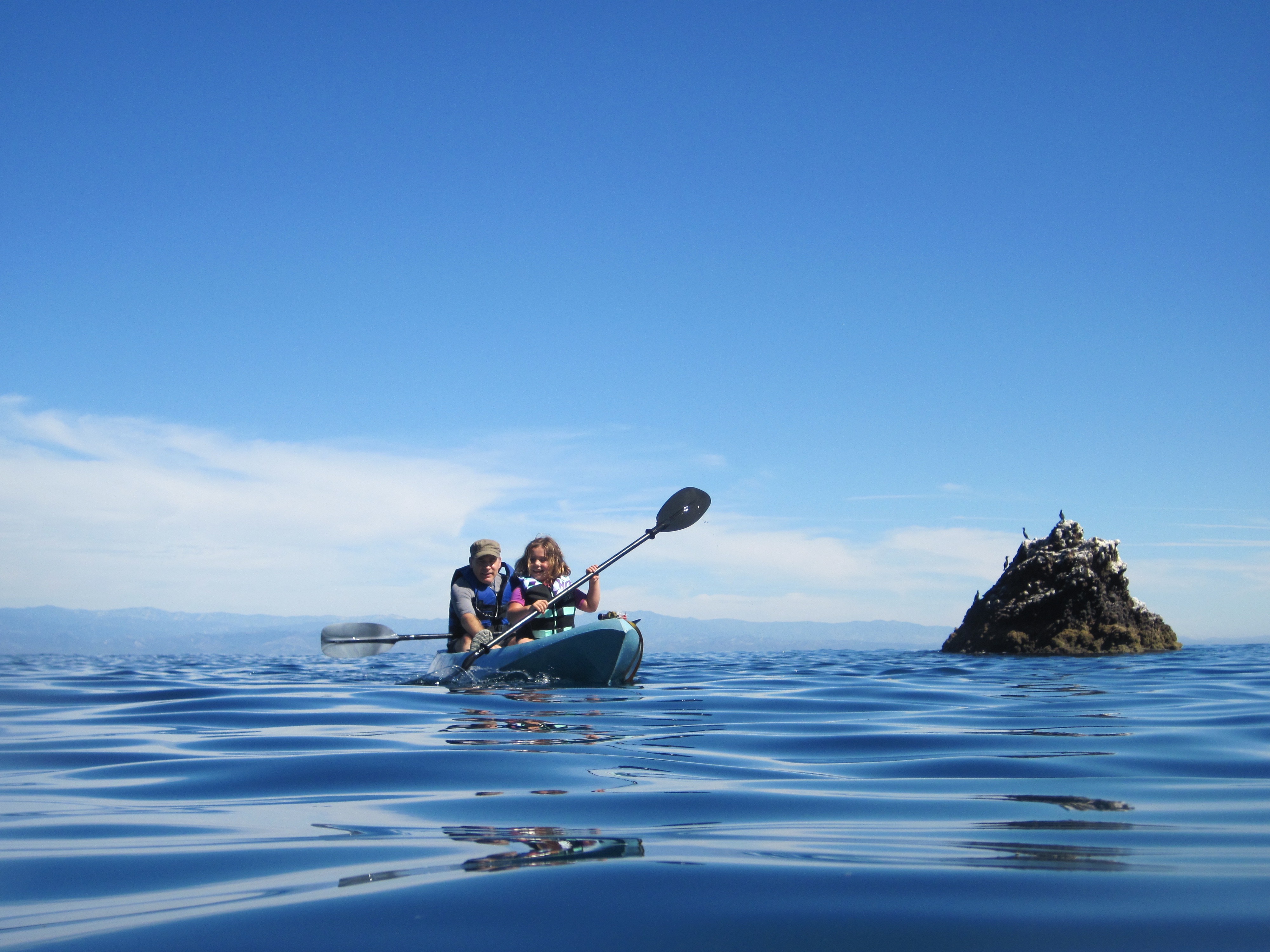 A father and daughter enjoy a kayak trip in NOAA's Channel Islands National Marine Sanctuary. Be sure to check the weather forecast before venturing out on the water, wherever you might be.