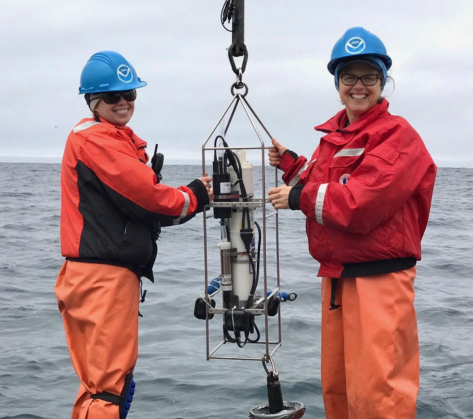 NOAA scientist Dani Lipski (left) and NOAA Teacher at Sea Jenny Hartigan (right) deploy a Conductivity, Temperature and Depth (CTD) device aboard NOAA R/V Fulmar off the coast of California. The CTD helps scientists to measure environmental conditions. Read about Jenny Hartigan’s adventures researching the California Current ecosystem on the Teacher at Sea blog. 