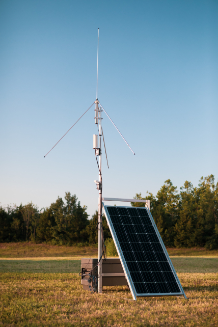 A photo of one of the sensors in the NOAA National Severe Storms Laboratory's portable Lightning Mapping Array (LMA). The sensor consists of an aerial with a solar panel in front of it.