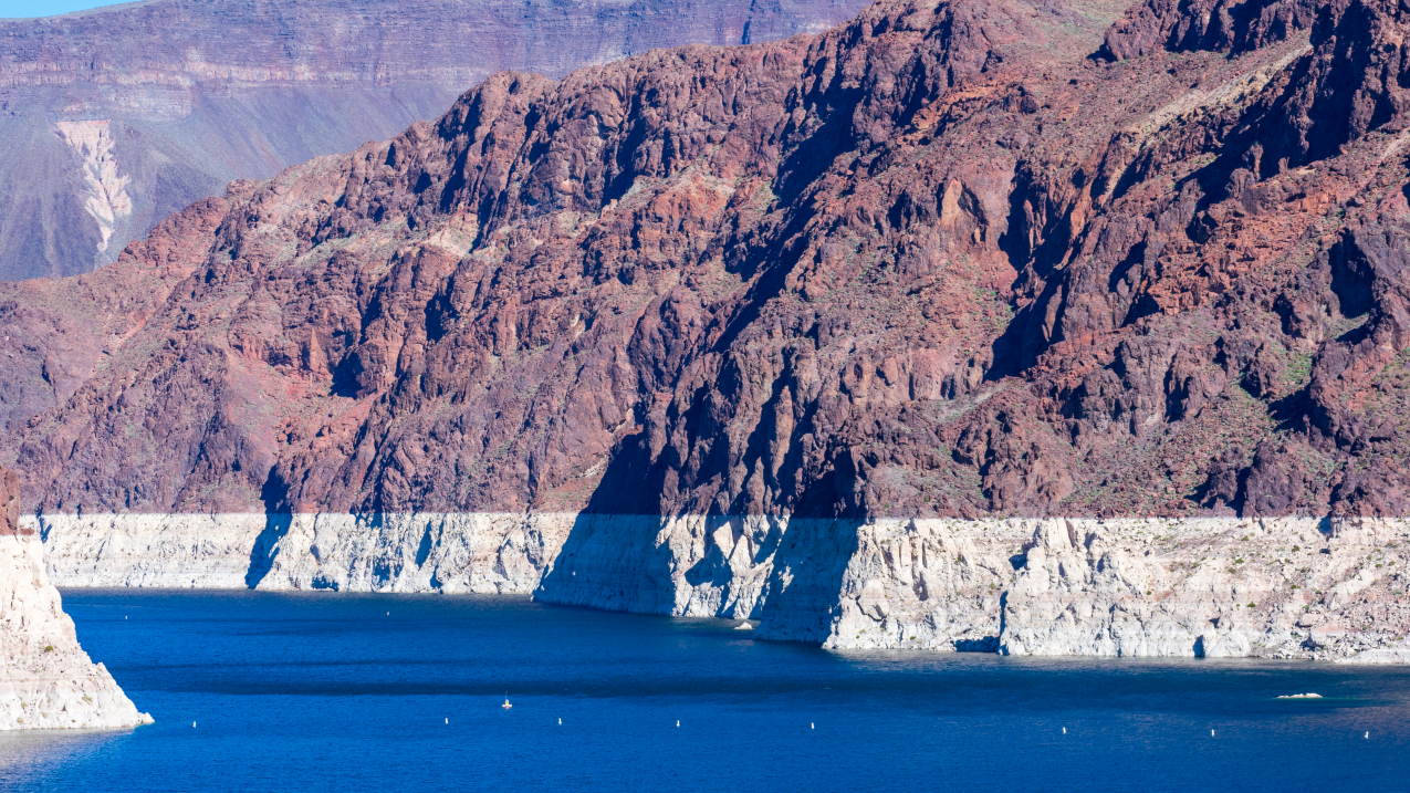 A white "bathtub ring" exposes the former waterline in Lake Mead during low water levels in July 2021. 