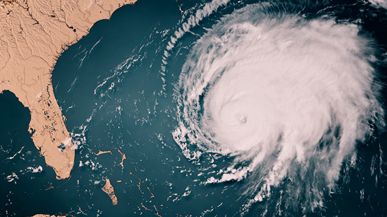 A realistic graphical recreation of a satellite photograph showing a hurricane in the water approaching the east coast of the United States.