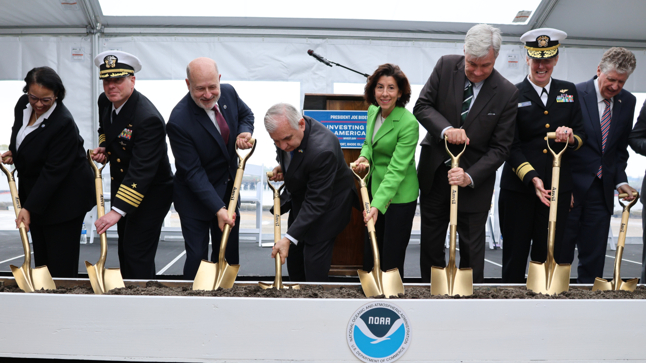 Photo of individuals digging with gold shovels as part of the groundbreaking ceremony for NOAA Marine Operations Center-Atlantic on May 6, 2024.