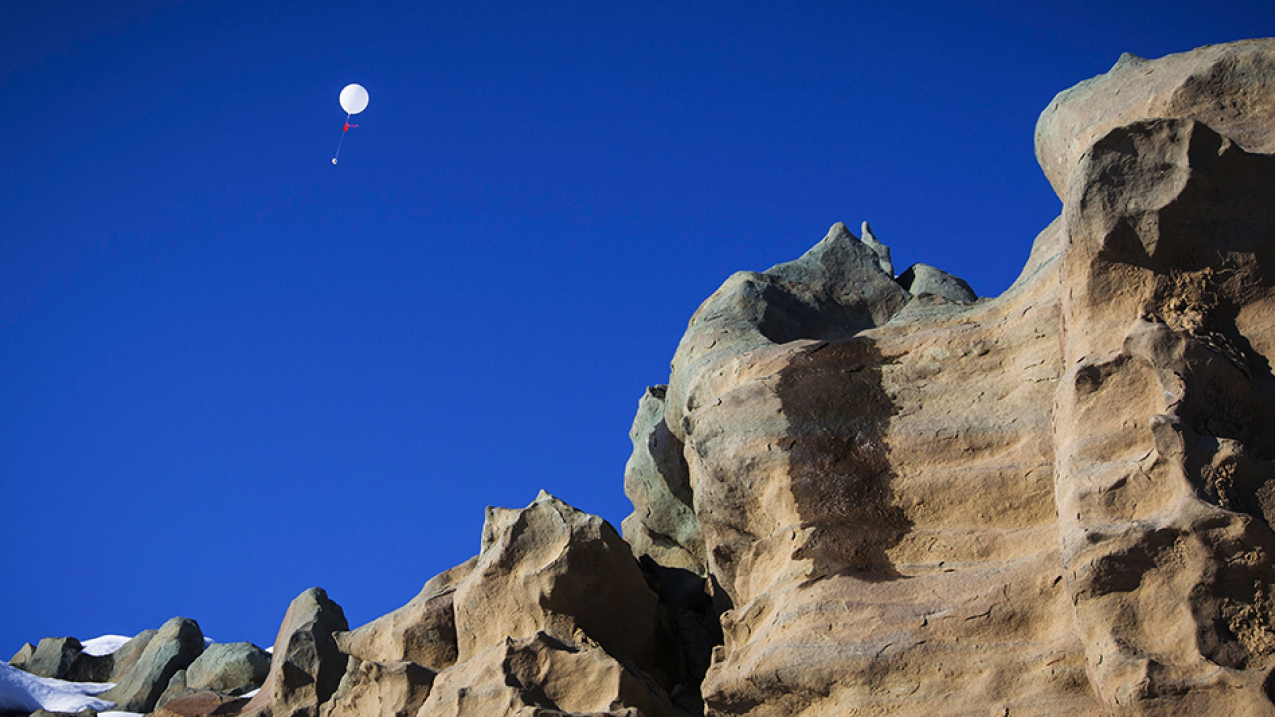A weather balloon fitted with an ozonsonde –  an ozone-measuring instrument – rises above the rock formations of Fantasy Canyon, Uintah Basin, Utah in 2013. NOAA's National Weather Service is now piloting an initiative to automate balloon launches in Alaska (Spring 2018).