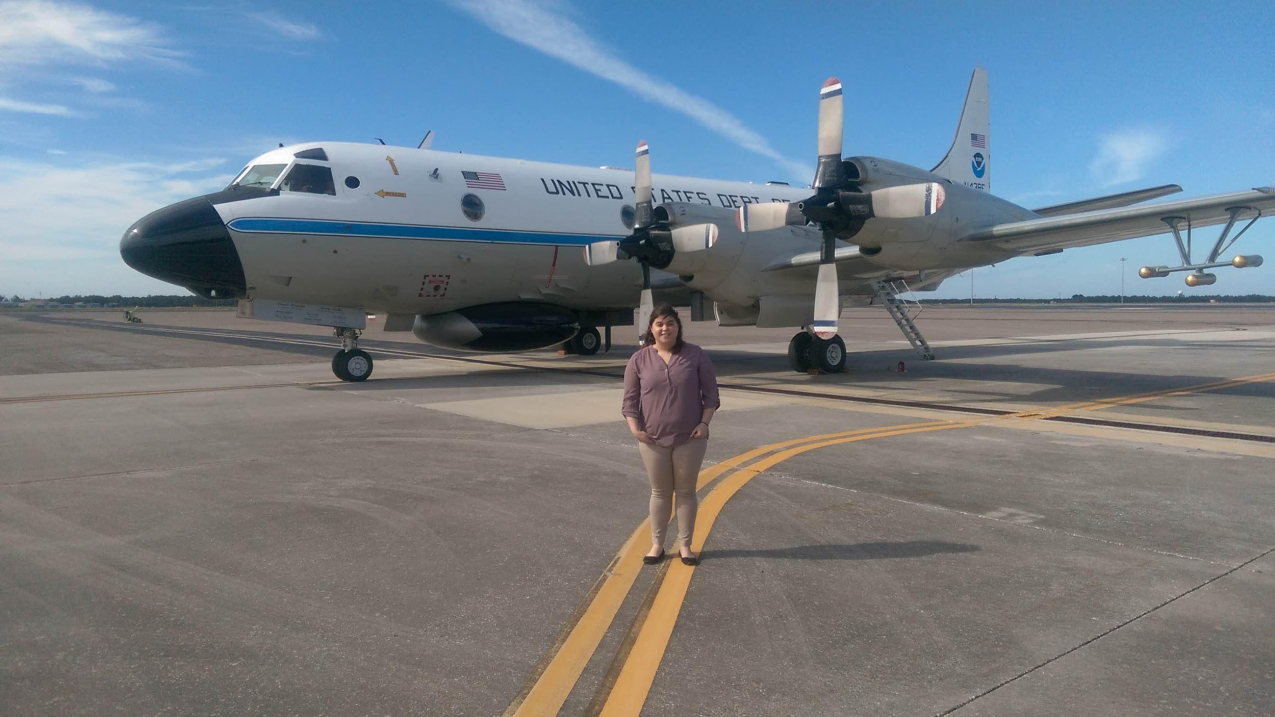 Hollings Scholar Lauren Cutler in front of a P-3 "Hurricane Hunter" aircraft during her internship at MacDill Air Force Base in Tampa, FL.