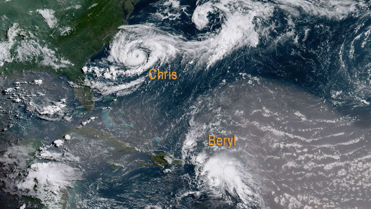 GOES East satellite image of the western Atlantic Ocean, captured July 9, 2018. The small eye of Tropical Storm Chris is visible off the coast of the Carolinas, while in the eastern Caribbean Sea, we can see the remnants of former Hurricane Beryl, around which a thick plume of Saharan dust is wrapping north and east of the storm. 