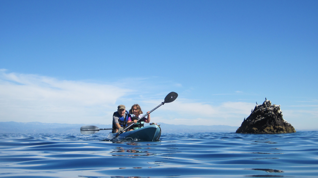 A father and daughter enjoy a kayak trip in Channel Islands National Marine Sanctuary in California.