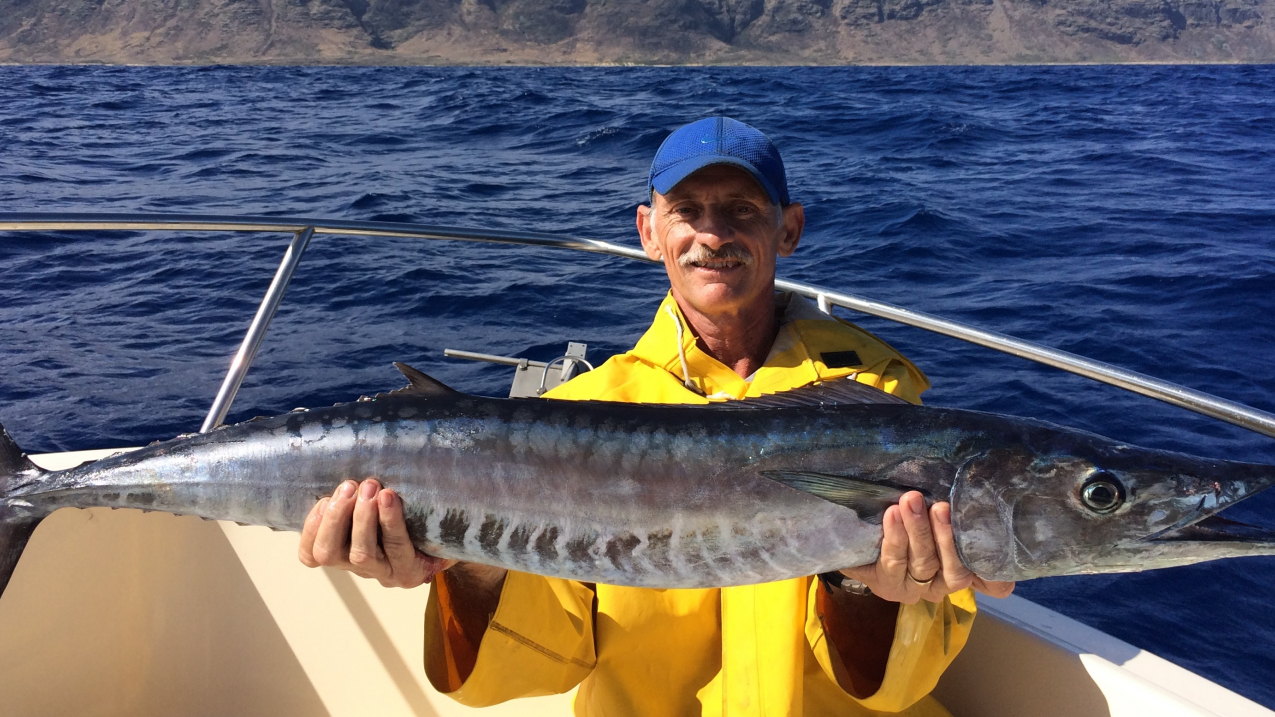 Recreational fisher proudly showing caught wahoo