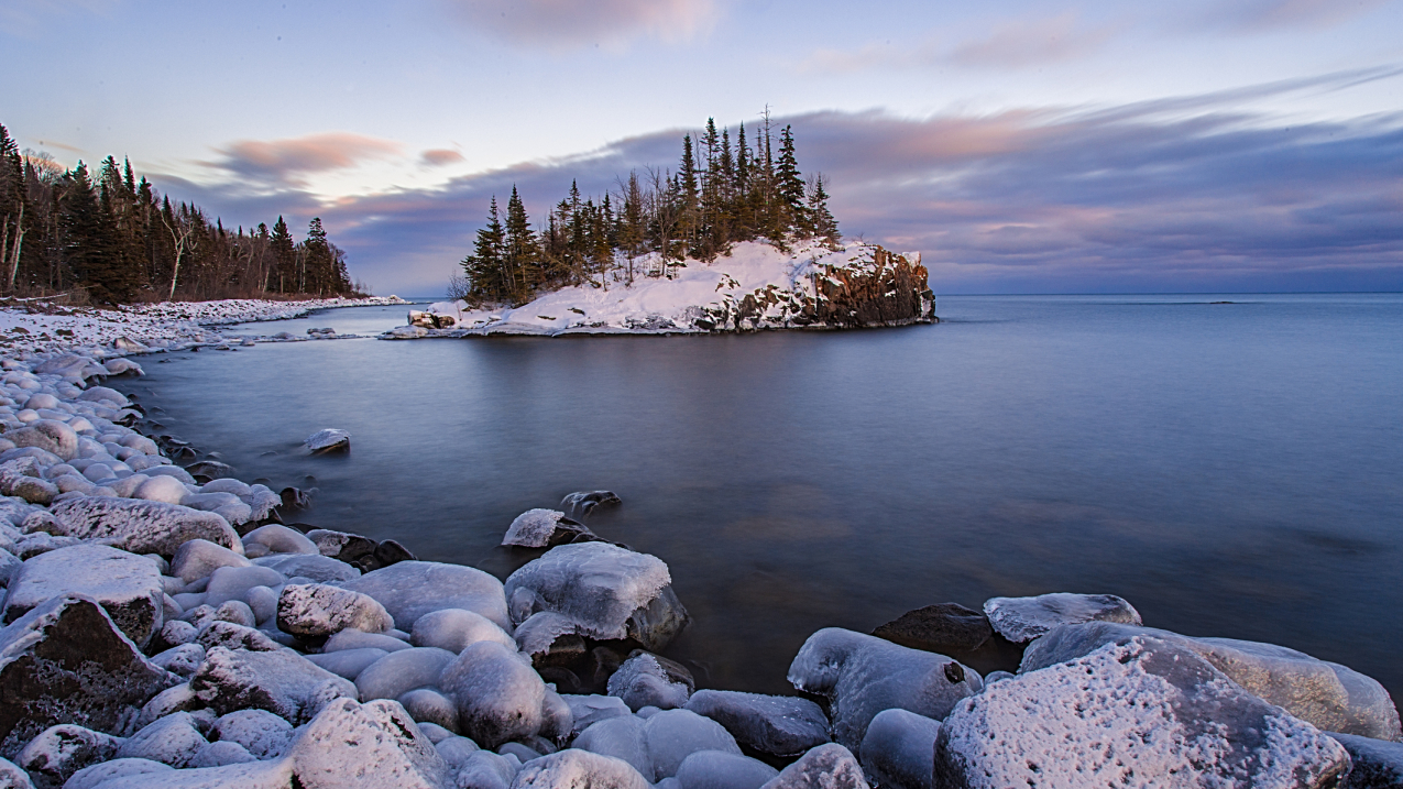 A small snow-covered island off the rocky shoreline of Lake Superior in Minnesota. (undated stock image).