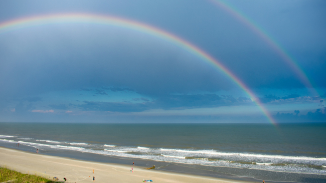 A double rainbow shines through dark clouds above North Myrtle Beach, South Carolina.