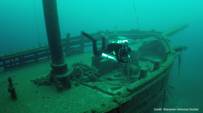 A diver swims through the wreckage of the Walter B. Allen schooner