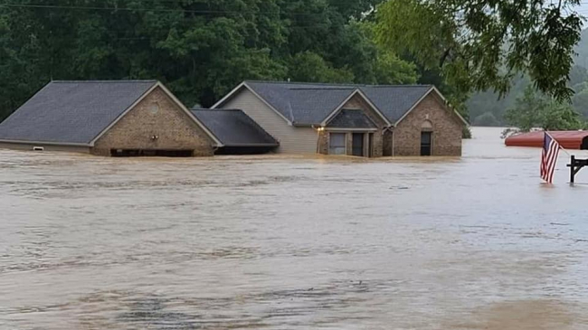 A house and garage submerged in high flood waters in Waverly, Tennessee, after a complex of thunderstorms dropped more than a foot of rain across parts of central Tennessee on August 21, 2021. 