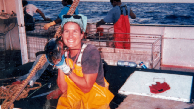 Lesley Hawn poses with a small tuna as a Hawaii-based longline observer.