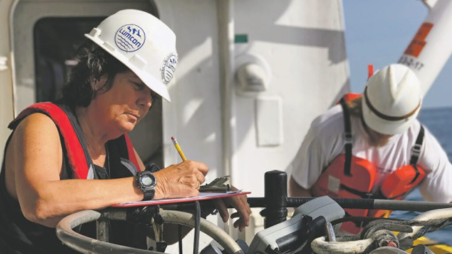 Photo of Nancy Rabalais recording data during a cruise aboard the R/V Pelican in the Gulf of Mexico to study hypoxia. 