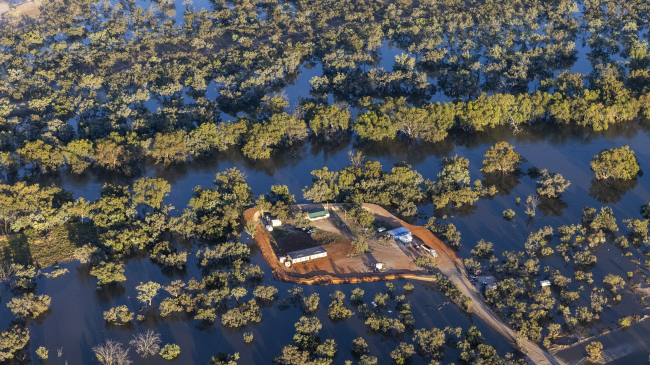 An aerial view of a property surrounded by flood water on December 9, 2022, in Louth, Australia. Prolonged flooding along the Barwon-Darling River and its tributaries due to unseasonably high rainfall turned vast swaths of the Western Plains into islands, cut off from road access. 2022 was the warmest La Nina year on record as increasingly extreme and changing conditions impacted the globe.