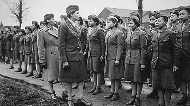 Army Maj. Charity E. Adams and Capt. Mary Kearney of the 6888th Central Postal Battalion inspect the first contingent of Black members of the Women's Army Corps assigned to overseas service in Birmingham, England, Feb. 15, 1945.