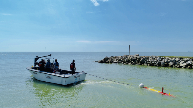 NOAA scientists prepare to launch an underwater robot in western Lake Erie that is designed to map harmful algal blooms and measure the toxicity of the algae