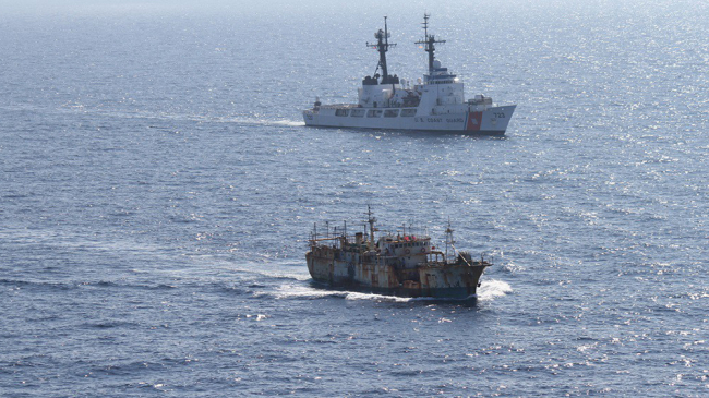 The crew of the Coast Guard Cutter Rush escorts the vessel Da Cheng, suspected of high seas drift net fishing, in the North Pacific Ocean on August 14, 2012.