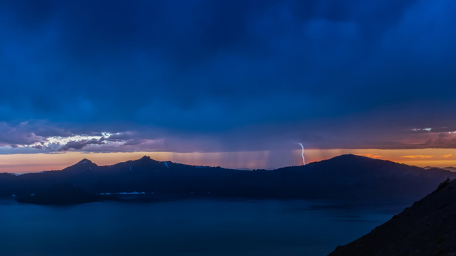 A lightning storm at dusk over Crater Lake in Oregon