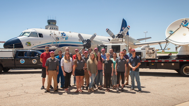 NOAA and Cooperative Institute researchers pose with some of the instruments they will use to gather data in and near thunderstorms during TORUS on May 14, 2019 in Salina, Kansas.