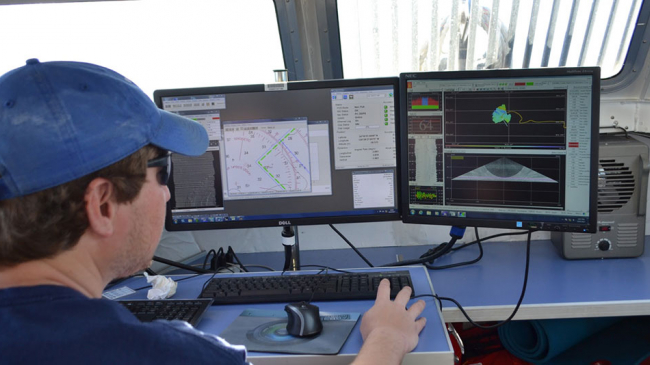A NOAA survey tech collects backscatter data on NOAA Ship Rainier in California's Channel Islands to support safe navigation and habitat mapping.