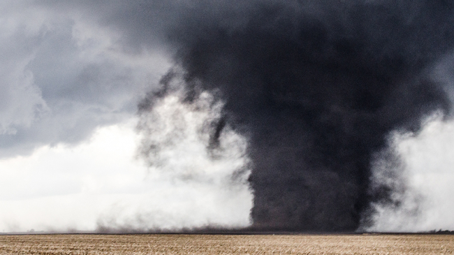 A tornado churns up a field outside Washburn, Illinois on February 28, 2017.
