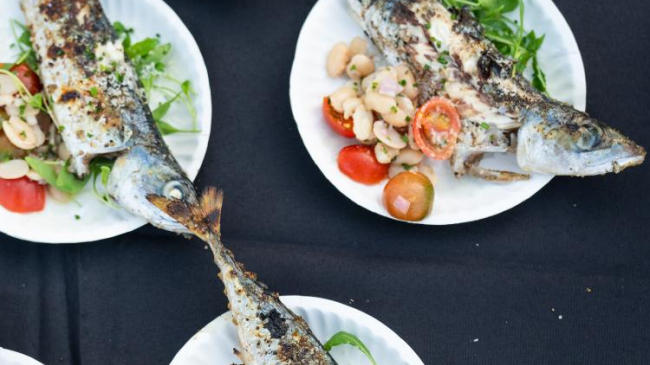 Whole grilled Pacific mackerel pairs deliciously with roquette, heirloom tomato, and hazelnut and borlotti bean salad.