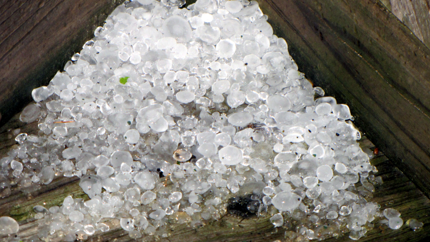 A pile of irregular, semi-translucent ice spheres that appear larger than five millimeters. Some are smooth, others have a rough texture.