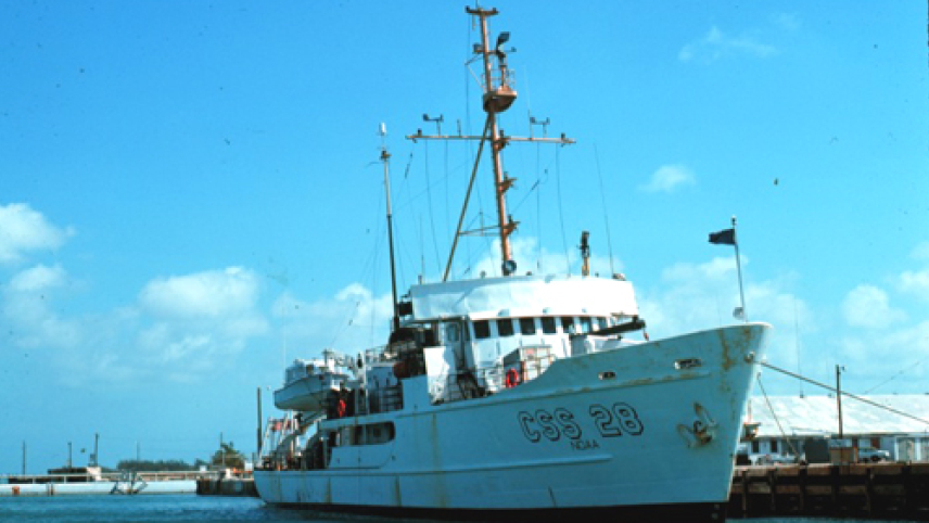 The now decommissioned NOAA Ship Peirce sits in the water at a dock. It was commissioned on May 6, 1963 and was the first ship in the uniformed service to have a female operations officer.