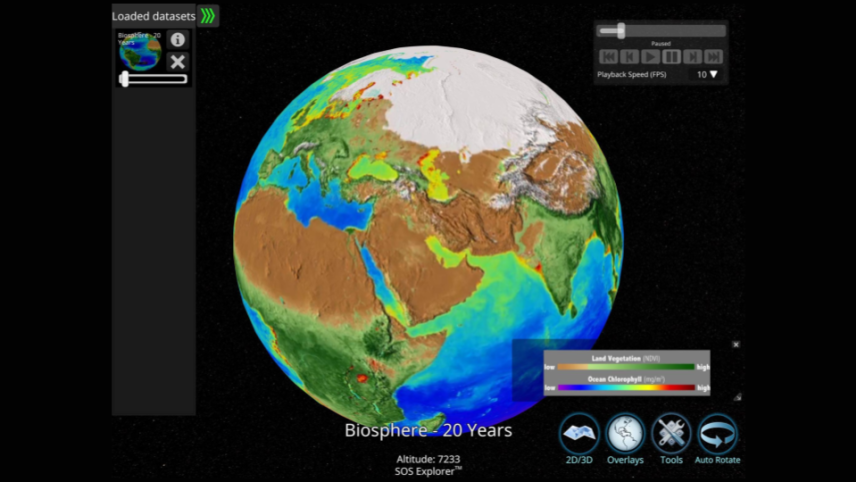 A screenshot of a dataset showing the Earth as a sphere on a screen. The ocean is shaded based on the chlorophyll (green pigment in plants) concentration. Greener water signifies an abundance of phytoplankton, while bluer water indicates less. Red patches in the ocean often occur at the mouth of a major river and indicate an abundance of life caused by run-off containing higher concentrations of fertilizers and other nutrients that find their way into the water source. The lands are shaded to depict the veg