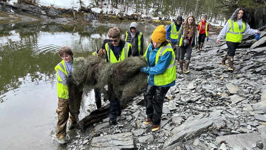  Students carry a derelict gillnet across a remote beach near Whittier, Alaska.
