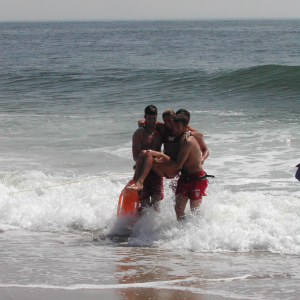 Lifeguards rescue victim from rip current.

